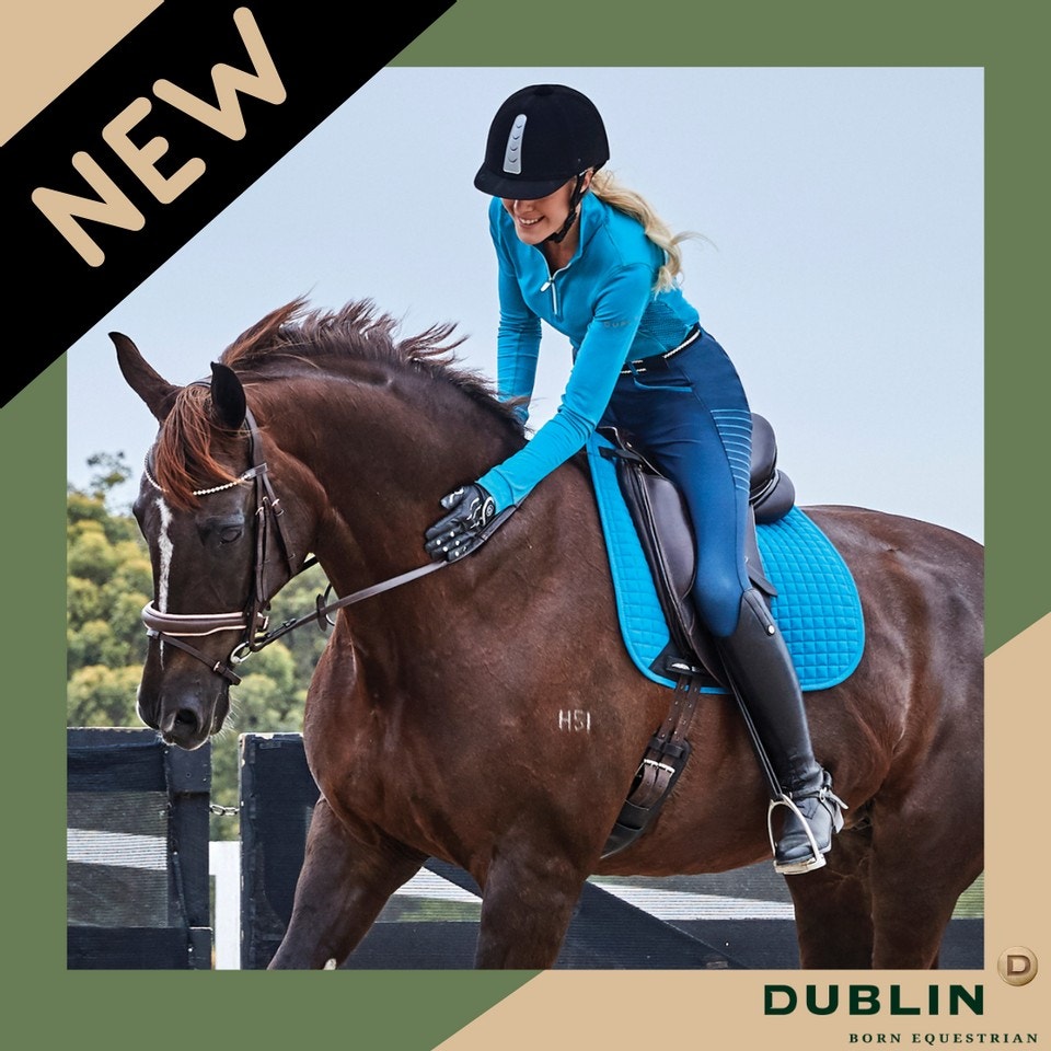 Girl wearing new dublin gloves patting her horse while riding