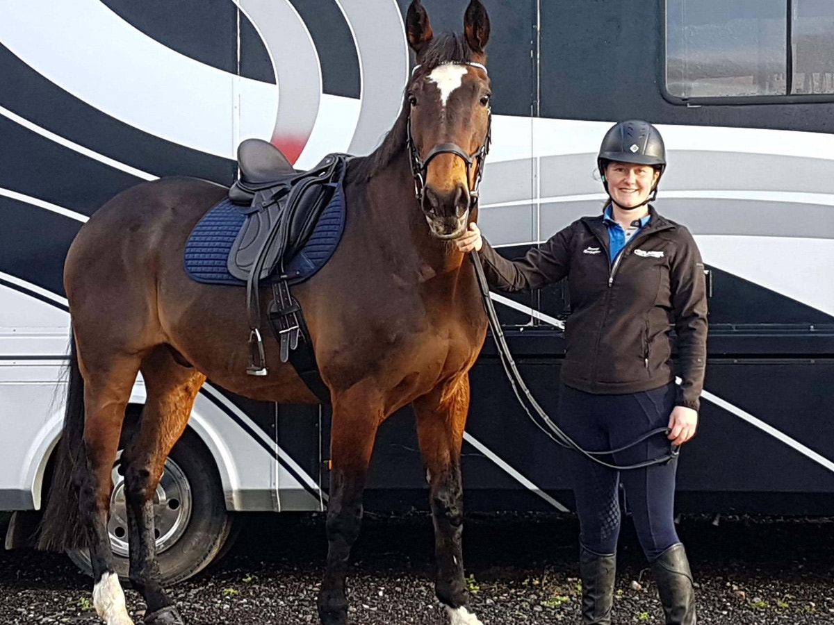 Jennifer Stringer standing with her horse wearing the Crosby Dressage Saddle